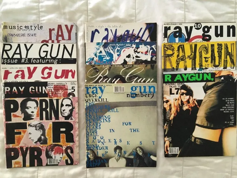 Early issues of Ray Gun magazine laid out on a bed